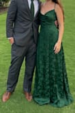 The fabric is really beautiful and elegant - a great sophisticated yet effortless deep green satin with floral. The cut is a little challenging if you're standing perfectly still with no wind, it's perfect. But if you're hitting the dance floor at an outdoor wedding with lots of wind, the slit goes ALL the way up, and the front drape design had me almost flashing strangers all night long. Both hands were constantly occupied in an effort to not flash people. If I wear it again, I'll definitely need some alterations first. - Brandi N.