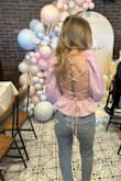 Wore this to my daughter's gender reveal and obsessed with the back! Runs a little large but with the strings in the back, it worked out! - Donna