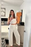 I've been wanting a jumpsuit for a very long time.  Being 6 ft tall, it's always a challenge to find pants that are long enough, so I almost gave up on the idea of ever owning a jumpsuit.  I'm glad I made this purchase!  The top is a little tight in the chest, so maybe I'll try it on with an unlined bra.  Love the wider strap design and the fact that the midsection is not too exposed.  I also love the fact that it's a two-piece and going to the bathroom would not be a struggle! - Valeria M.
