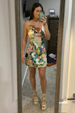 Very cute dress! The strings tie in the back of the neck so you can adjust as needed which is nice. It is a shorter dress, but I didn't think it was too short and covered my butt no problem. - Meagan W.