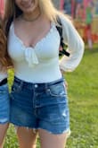 This FALLS off my shoulders so I went for a small and I'm not normally a small - only in some Lulus clothes. The sleeves fall off significantly so I swapped for a small. - Liz B.