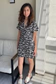 This fits gorgeously, like a modern-day 1940's meets 1990's look. The neckline is cut low for a little flirt, but not too much. The length is perfect and not too short. It's that perfect dress that you can throw on and feel confident & beautiful without any effort. The material is polyester, but it wasn't too hot on an 80 degree day. I normally wear a size Small and occasionally XS. I definitely needed to size up to a Medium in this dress. - Genevieve C.