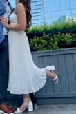 I wore this for my rehearsal dinner and loved it! The top may be a bit loose depending on your chest size. I wouldn't size down though unless strapless tops are normally loose on you. I thought it was really cute and was surprised the pleats held up after being washed! - Kaitlin E.