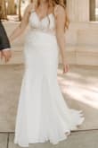 It does seem to fit a little snug (I ordered my normal size), but it wasn't tight enough for me to size up. The quality is amazing for the price and I just had to have the length and straps shortened.
Edit: I bought this back in late 2023 for my wedding in May 2024. It was so beautiful - Anna M.