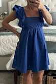 The blue color of this dress caught my attention as well as the ruffled sleeves, and I am not disappointed with my purchase! The material is a light cotton feel and you can see from the pictures it does need to be steamed or ironed, but nonetheless has a very feminine look to it. It's casual enough it can be worn as a nice summer dress or evening dinner out but also I think can be dressed up if you have a nice event. I did not get the dress on sale, and I share that to say that it was worth just getting it if you like it. It's a nice staple piece that will be in fashion for a while. I am petite framed and ordered the extra small and I have no complaints with the length or how it fits in the bust area, very flattering and classy. - Laura S.