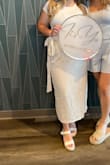I wore this skirt wedding dress shopping and absolutely loved it. I definitely should've ordered a medium. I haven't washed it yet so I'm worried about the comments saying the linen shrunk but the liner didn't. The wrap is super flattering but when you sit it does open right up. - Emma O.