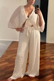 Overall the set as a whole is a lot of fabric! The top first material was bunching at the top around the collar in the back so I ordered a Large but the large is just way too much fabric. Not sure. I'm not loving these $2 restock fees to try clothes on especially when you are in between sizes! Please bring back free reruns Lulus! - Kristen M.