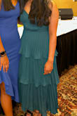 I ordered this dress for a graduation and it fit perfectly. I did not want something tight around the hips or tummy area and this was very flowy past the bust. I did have to put cups into the dress but a strapless bra would work fine too. Overall I love the dress and can't wait to wear it again. - Puja P.