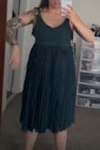 This dress (I bought a medium) had an excess of fabric from the waist down and then just made me look two times my actual size. The top portion fits ok, but the torso length is not as long as it is displayed in the picture. The bottom was so excessively stocked with fabric that you probably could parachute in it and land safely. Didn't wear it to the wedding, so I had to find an alternative dress. - Bahareh L.