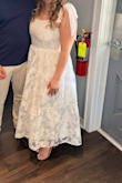 This dress was so adorable for my bridal shower! I loved how it looked on, and it fit me like a glove; the dress is very true to size. The material was a little itchy at first, but I got used to it. The biggest downfall of this dress was that it was extremely difficult to get it zipped in the back! I'm not sure if it was due to the zipper alignment or the material or what, but it took 4 people trying for over 30 minutes to zipper this dress. It made my fingers bleed trying to do it myself. And this was NOT due to the dress being too small. This was the only negative aspect of this dress! Otherwise, I did love it. - Savannah H.