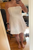 I really like this dress! It is a good length - short but not so short that I feel like I am going to flash anyone. It fits really well and you can tighten the top with the laces in the back to get a perfect fit. The top edge has an elastic-type band around it to help it stay up so it doesn't feel like I'll have to be tugging it all night. - Brittany M.