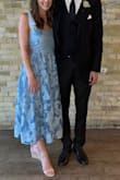 I wore to a semi-formal/cocktail wedding as the girlfriend of the brother of the bride. Endless compliments and it was very flattering. It's darker in person than I expected but still beautiful. Some stray strings but not obvious/were able to cut down. I was worried the itchy seam at the bust would be problematic but my bra helped lift it off my skin/acted as a barrier. The zipper required some manipulation to zip up. The bows laid beautifully just make sure they are tied tightly. I ordered my regular size and the bust was snug but comfortable. I'm glad I did not size up as the length would have been too long/awkward and straps too loose. I would recommend this dress! - Mallory M.
