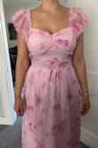 I love the romantic feel of this dress with the ruffle sleeves and bow back! I purchased this for a wedding I'm attending this summer. The fit seems to work with a larger bust! The color/pattern are pretty in person, but as others have noted, the sewing on the bodice was not the best. It seemed like the fabric below the bust was not pulled taut, so it kept bunching right below the waistband. The ruching at the center of the bust was also pretty crooked. The fabric is very light, but not see-through, which I don't mind for a summer wedding. However, I know the issues with how the fabric lays on the bodice is going to bug me, so I will unfortunately have to return this. - Ashley M.