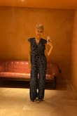 I bought this a few years ago in a medium, and I've fluctuated in weight and now bought the large. I love it. It's such a versatile and comfortable outfit. The fabric is thin and doesn't stretch, but it feels supportive. - Jessika I.