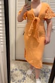 This dress fits perfectly except at the top. I have a smaller bust, and this doesn't look good on me without a push up bra. I'd need to buy a different bra because I can't figure out how to tie the top without showing my bra - Allison Q.