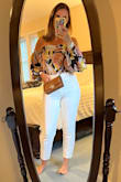 First of all, I can see why other reviewers had trouble getting this top on; however, my second time trying it on I realized there is a side zipper! That is a game changer. The back button would be impossible for me to do without assistance but maybe if you are a contortionist you could get it on your own. I am determined to make this top work and will definitely be using double-sided tape to reinforce the chest area. I got a large and it's a little loose, but I think a medium would feel restrictive. I think this top is actually forgiving and flattering but time will tell after a night out! I like that it's a unique style and that the colors are appropriate for summer or fall, depending on the bottoms or accessories I will wear with it. I gave it three stars because it was tricky to put it on and will need some reinforcing to keep it in place. - Caitlin R.