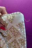 This purse is gorgeous! I bought it for a Gatsby themed party. I just pulled it out of my closet to use for the second time and noticed that it's already unraveling - Jennifer R.