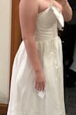 I was obsessed with the photo online and thought it would be perfect for my bridal shower. It was a nice quality, but too long for me and would have needed alterations. Then the bow was not sewed onto the dress and poked out so that was a bit odd. - Jamie W.