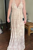 This dress appears more nude color in photos. For anyone under 6ft, this will need to be hemmed. It is beautiful but also heavy. Just not what I thought I was buying. Definitely can't wear it to a wedding like I had planned. - Hannah L.