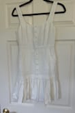 The dress is made from a linen material so it wrinkles and the white is see through. You can see pockets and inner lining. The sizing is also very off. I wear a true S, sometimes XS. Ordered a small in this and cannot get it zipped past my ribcage. I had high hopes for this for my wedding week but sadly, it is a return. - Sarah H.