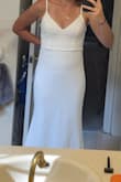 It fits great! The fabric is of decent quality. It has some weight to it, like a typical wedding dress, but no boning or padding so I feel more natural in the dress. I'm excited to wear it for my backyard wedding!
Note for pic, I couldn't zip it up by myself so I had to hold it close. - Autumn P.