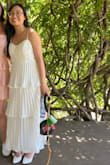 It was a lovely dress, perfect for a simple summer wedding/civil ceremony! Loved twirling around because of the 3 tiers and added a lot of dimension. Got lots of compliments and people asking where I got it from! However, I did think that the positioning of the bust was oddly high (I am by no means well-endowed but the top portion fit a bit weird IMO). Another con is that it's really hard to iron out the wrinkles (it comes with the territory for buying a pleated dress) but isn't too noticeable in photos - just IRL standing in front of a mirror. Not see through at all. - Victoria N.