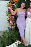 The color is a true lavender purple, the dress is stretchy, and it's super cute! The only thing is my hips are bigger than my waist so where the ruching in the dress and the tulip slit overlap, doesn't exactly overlap right and creates a few more ripples. Didn't look bad though, just had to adjust every once in a while. I'll definitely wear it again. - Sydney E.