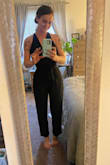 This romper is adorable. It's belted at the waist and is very figure flattering. It comes up high enough in the back a regular strapless bra can still be worn. I am 5'8, 140lbs, normally a size 6, and a Medium fit very well. It is a little big on top (I am 34C) but nothing I can't work with! - Rachel M.