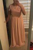 I originally ordered this dress in a small (see pictured) and it was a little big. I returned and ordered an XS and it wouldn't zip up. I returned the XS and ended up getting the small again. I will likely just alter it. It's a great dress. High quality, great color, exactly as pictured. It's high quality, especially the lace. - Tammy T.