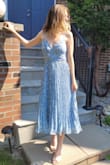 This dress is stunning! I wore it to a bridal shower and got lots of compliments on it! The colour and pleats are so beautiful and perfect for the summer.  The dress does have a bit of a shimmer which doesn't pick up on camera so be mindful if you don't like sparkles (I think this makes it look a bit more fancy than a regular floral midi dress). I was worried about the dress fitting too small but I think if I sized down it would have still fit well since the fabric isn't too stiff. I sized up in this dress so it was slightly loose but I was quite happy with the fit having this in mind. - Alie E.