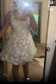 I was so excited to buy this dress but it's not exactly as pictured. The color is slightly off. It's really a nude dress with white appliqués over. The tulle and chiffon like materials feel so cheap they are not the most comfortable to wear either. I really wanted to love this dress. It might still work for my courthouse wedding but it's definitely not what I expected to be receiving. - Adeline T.