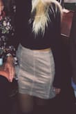 Its a little more muted than it appeared in the photo. I have this skirt in another color too and this one I feel like fits a little more loosely than the denim one does, but it still fits! Overall very cute! - Peyton K.