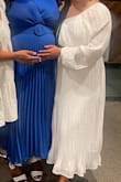 I hosted an all white baby shower for my friend. Her theme was "Heaven Sent". This dress was very flattering. It fits to size so if you're in-between sizes, go with the larger dress. There is no "give" around the band area. - Natasha P.
