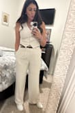 It fits well. You won't need anything under in terms of a bandeau etc. I wore it for a flight. The material is soft and the perfect thickness. - Dianne L.