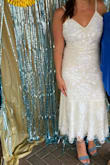 I wore this dress for my bridal shower and received more compliments than I could count. The dress would actually be the perfect option for a not-so-fancy wedding dress. It hits about mid-calf on me. The beading makes it really stand out. Fit was perfect in a small - I'm almost always a small but occasionally a medium. It is pretty low cut in the back making it quite difficult to wear a bra of any sort - Cristina S.
