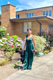 First of all, I bought this jumpsuit on final sale so I really hoped it would work. I fell in love with the color and when I saw it in person was even better so rich and dark green... Just what I wanted. The material feels so nice and the satin fabric is light and makes it look very elegant. I received tons of compliments on this outfit throughout the night. The only con is that I had to have it hemmed because it was extremely long (that was an easy fix) but the part where there is no strap was a bit big (also because I am a small 34B!) and was falling down often. I had to tighten the strings to the bra's clear strap underneath and it worked! (I also used a tiny safety pin. Overall, I loved it and highly recommend! - Meg S.