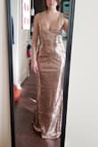 It fit nicely, but I would have probably needed to get the straps altered. I'm a small up top and a medium down low in fitted dresses.  Ultimately I returned it because the color kind of washed me out, since I'm so pale. I was purchasing it for a Mardi Gras ball. If your tan or a darker skin tone, I think you will love it. - Allison V.