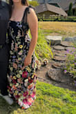This dress is a perfect fit and I was so impressed by the quality. It's not lightweight, but also wouldn't say too heavy. The tie straps are also great for adjusting. I wore two 2 weddings and a bridal shower, and received so many compliments! I highly recommend, if you are on that boarder line L/(closer to) XL I would recommend sizing up. - Katie C.