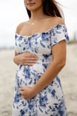 I got this dress for our gender reveal and loved it! Cute and fits well. There is an extra layer of fabric to keep undergarments from showing. I am happy with the quality! - Karly G.