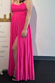 I typically wear XS or size 0/00 in pants and this dress fit perfectly along the bodice. The color was perfect for our "hint of pink" dress code.
The slit up the leg is high so I wore shorts under it. I'm a short gal, so I had to get creative for the length of this dress and ended up tucking the dress band under itself which created a beautiful seamless fit. - Courtney V.