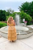I loved loved this dress for a wedding I attended. The fabric is sparkly in the sun. Dress fits true to size and you tie the straps so you can control how tight or loose they are. The ruffles are just perfect! They twirled around on the dance floor. - Marissa B.