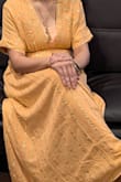I wore it for a night gathering and bought a cami which matched closed to the dress(peach/coral) color and paired with a good neckpiece that went well with the gold in the dress.Loved the color and style of the dress. Got many compliments!! - Versha R.