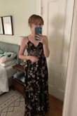 Based on size charts and reviews, I knew a S would probably be the right size for me, but I bought this in XS because it was the only size available and was the only dress that caught my eye (kind of a picky dresser!). It's definitely snug to zip up and I feel a little tightness in the rib cage, but in all other aspects I think this dress fits perfect. As a member of the IBTC, I am impressed that the cups don't gape and the straps are adjustable - no alterations needed. A HUGE win is that the length is perfect! All things considered I think a small maybe would have been a little too roomy, mostly in the bust area. As for the style, I love love love the sheer panel in the midsection. The embroidery is also beautiful. I love that it's a dark colored dress that will also suit a summer wedding because of the material and flowery design. I feel like it is a great choice if you aren't into frills and bright colors, but want to add some fun interest to your wedding guest outfit. - Lauren S.