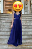 I ordered this dress for my 15 year old daughter to wear. She usually wears an XS, but it was too tight in the chest area (couldn't even zip the top), so we had to size up to the small. The small was a bit large in her waist and too long, so we had the waist taken in and the length hemmed. She absolutely loved it and looked stunning in it! It is a beautiful blue color, but not quite as dark as the picture (almost looks like it could be a little purplish when in the sunlight). - Lara C.