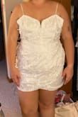 The wrap part in front would cover a tummy well but it runs small, I'm mostly XL in most brands and a different Lulus dress fit in XL so this dress just is tight so size up. Also no wiring in the cups on the chest. - Erin H.