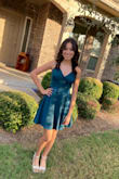 I wore this to my HOCO dance. The color is more teal than emerald green but that didn't bother me. The fabric is shiny but comfortable. I did have to knot the tie back to keep it from coming undone but overall, I loved the dress and I am happy with my purchase. - Tania A.