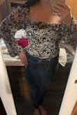 So, to me, this top runs a little small. I have A cups, so if your bust is bigger than that, you may need to go up a size. I also have a short torso, so it's not as short on me as some people, I'm sure. This may fit more like a crop top for longer torso ppl? I will have to break down and buy some high-waisted jeans to go with this top. The jeans I have on in the pic are mid-waist and you can still see some skin. I have short arms, and the sleeves are not too long. All in all, it will be cute with high-waisted jeans and maybe a pair of boots for the fall. - Brittney S.