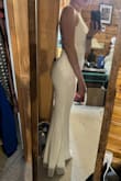 This dress really shows off my butt! Definitely accentuates the curves on the bottom end. The top seems to squish and flatten out my boobs a bit, so I had to add some sticky cups so that my boobs didn't look flat. The material is stretchy and comfortable to wear, and it is not see through (so I'm not worried about bra/underwear showing, which is great). This dress was a little too long for me, but with heels, I'm able to manage. It is just a little hitting the floor while I wear it with heels, but the material is substantial enough that I'm not worried about it. I'm wearing this as my reception dress for my wedding. It's way more comfortable and flattering than the dress I went to a bridal store and paid $1400 for that I'm wearing at my ceremony. - Heather P.