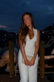 I purchased this jumpsuit for an all white party and it was a HIT. It was super comfy, especially in the hot August weather and it didn't feel super tight or restricting at all. It runs true to size. I personally ordered an XS and it fit perfectly. AMAZING. - Adelina D.