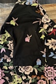 In the picture the dress has full embroidery on the front of the dress 
I received my order and there is no embroidery on the front of the chest. 
It is solid black. Also not sure what is on the dress. Didn't even try it on but I could not save my review unless I chose an option. - Kristine D.